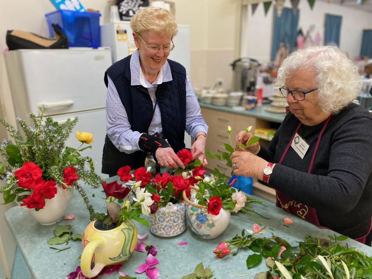 Denise and Gwen creating the table arrangements